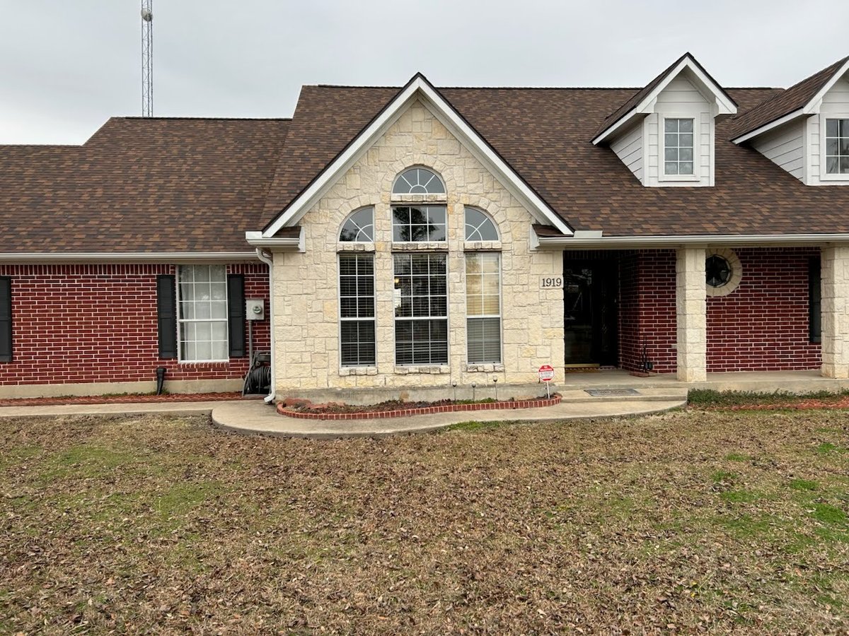 White brick home with residential glass windows in North Texas