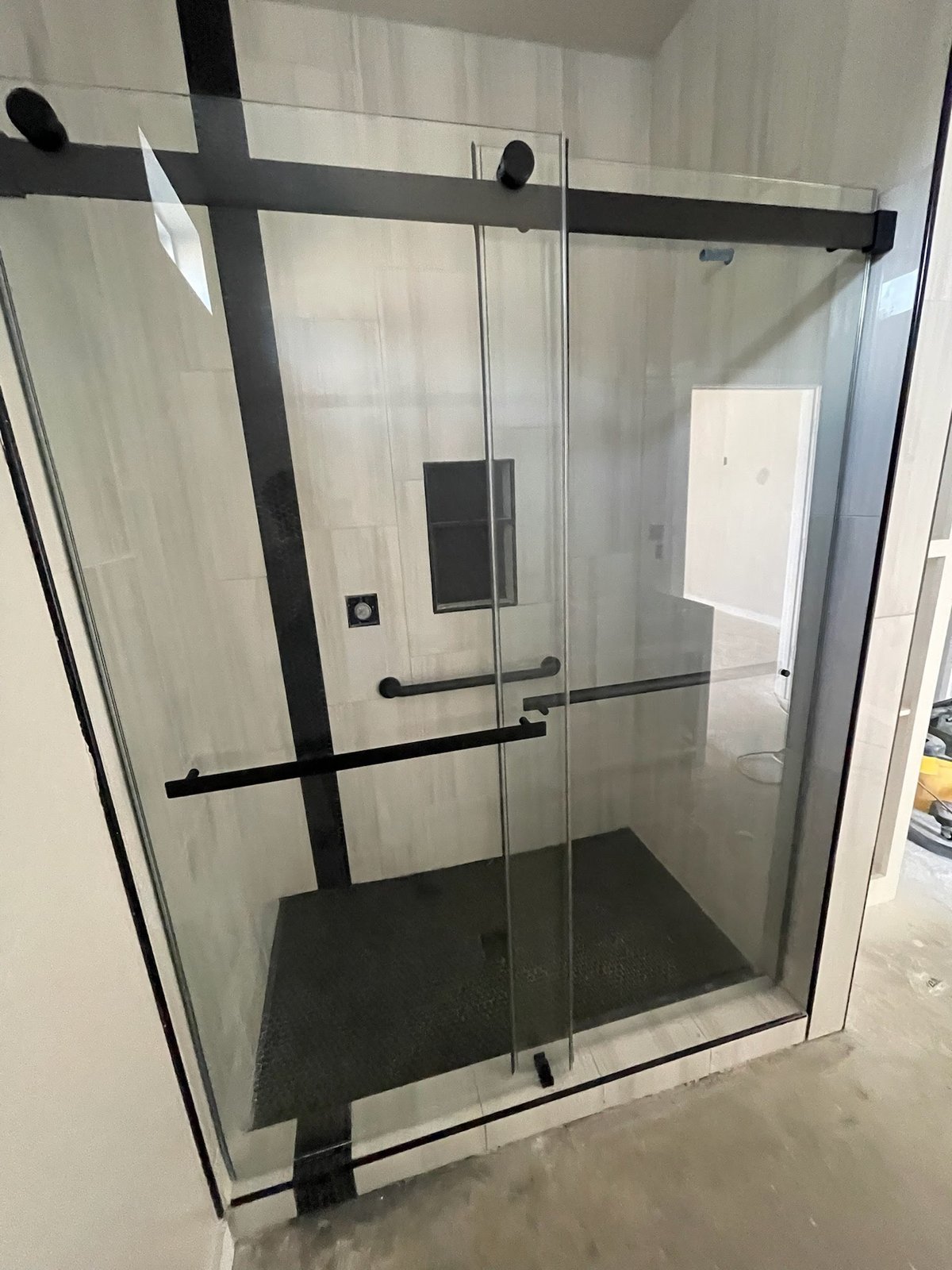 Black-framed glass shower enclosure installed in North Texas